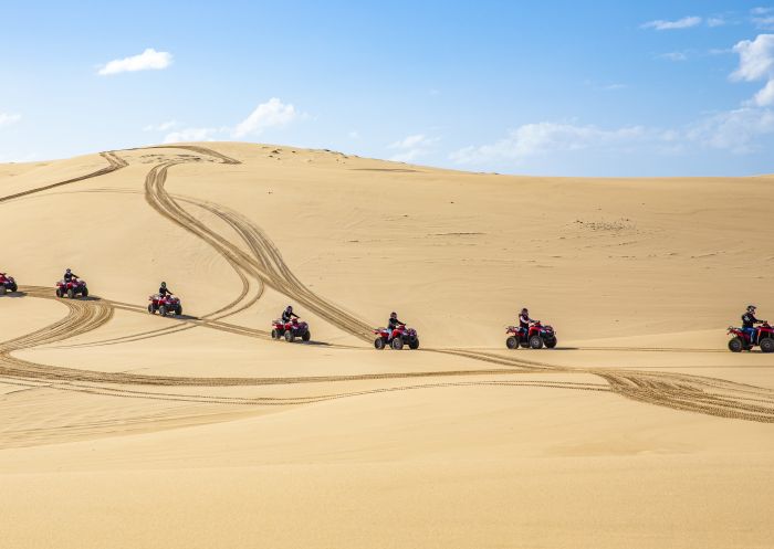Small group enjoying an Aboriginal cultural tour on quad bikes with Sand Dune Adventures, Port Stephens