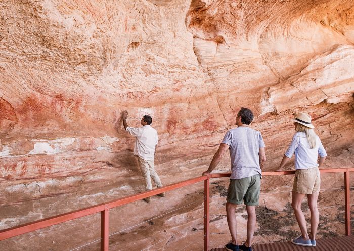 Mutawintji National Park tour guide Keanu Bates showing visitors Aboriginal rock art at Mutawintji Historic Site, Mutawintji
