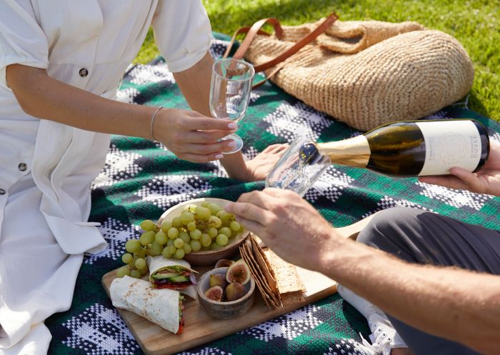Couple enjoying a picnic in the scenic Japanese Garden and Cultural Centre, Cowra